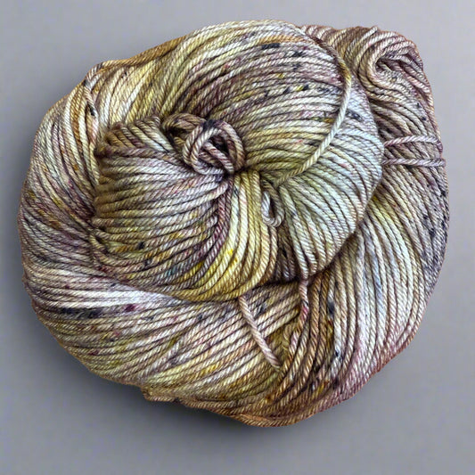Swirl of multicolored yarn on a gray surface