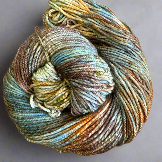 Multicolored skein of yarn on a gray surface